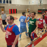 Adult Unified Basketball Teams giving high fives after a game.