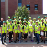 Photo of volunteer in hard hats and safety vests